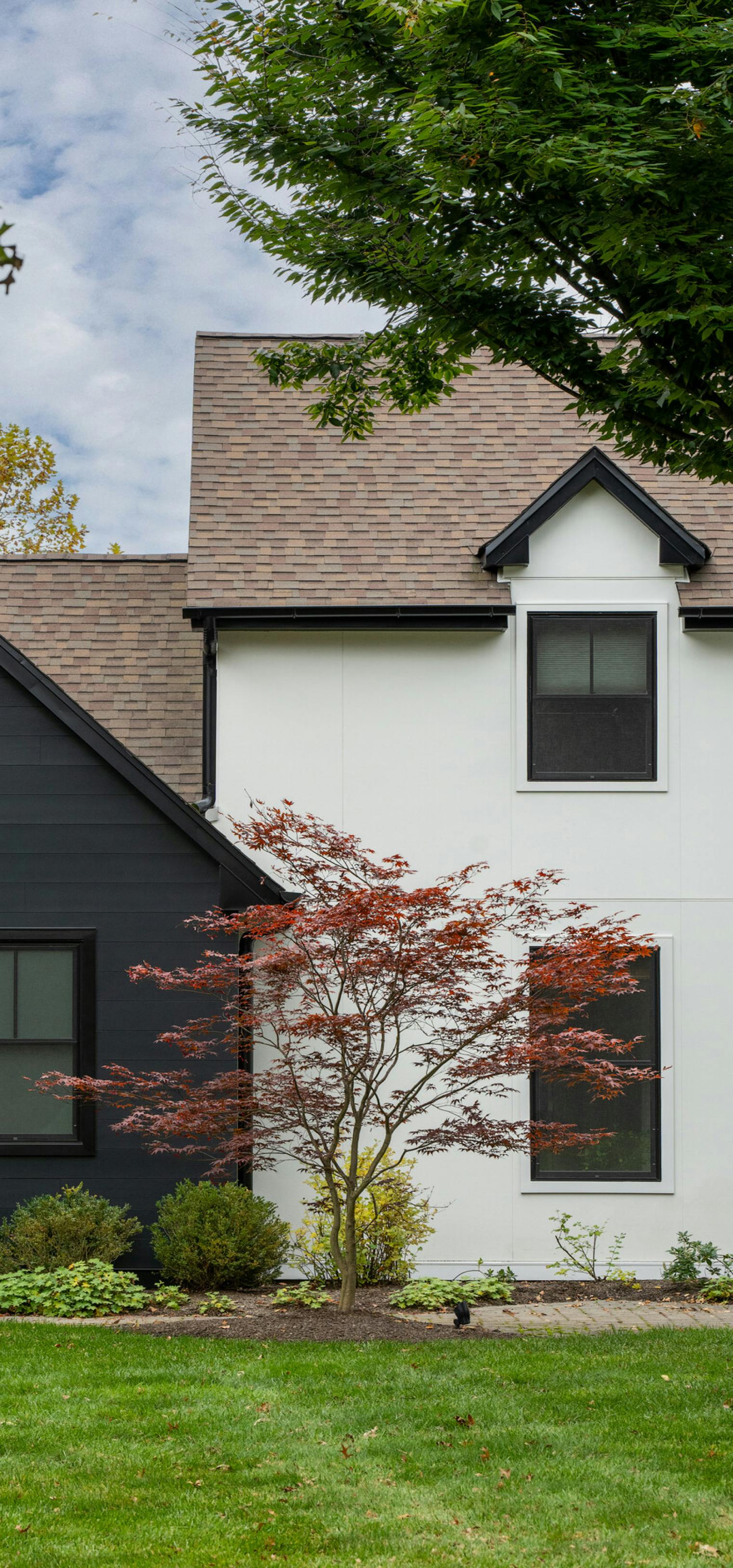 colonial house with hardie architectural panel and artisan  shou sugi ban and summer white