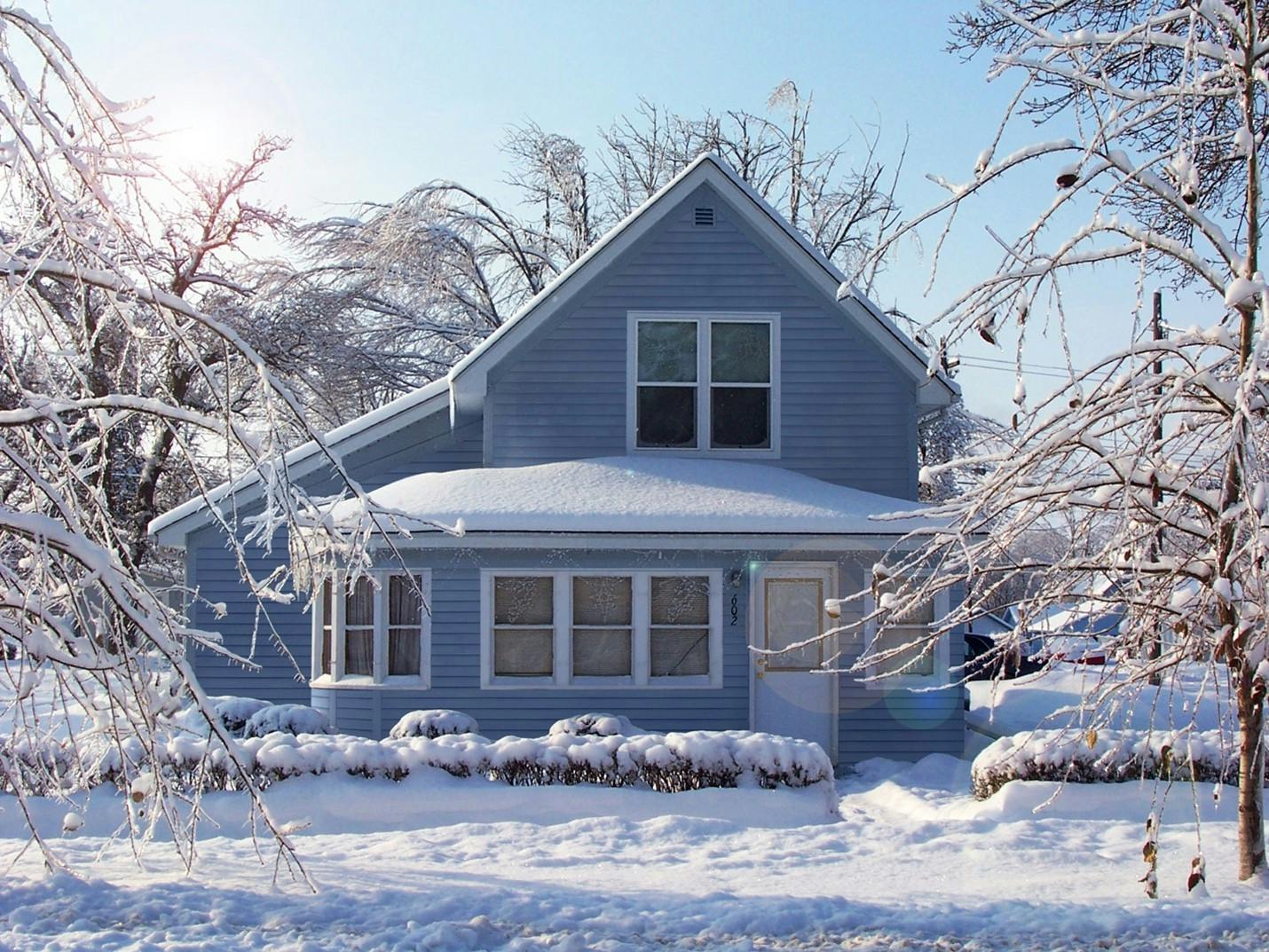 Snow covered house with blue James Hardie Siding