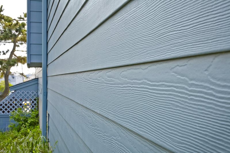 Section of a building's exterior featuring horizontal wooden lap siding that overlaps at each joint
