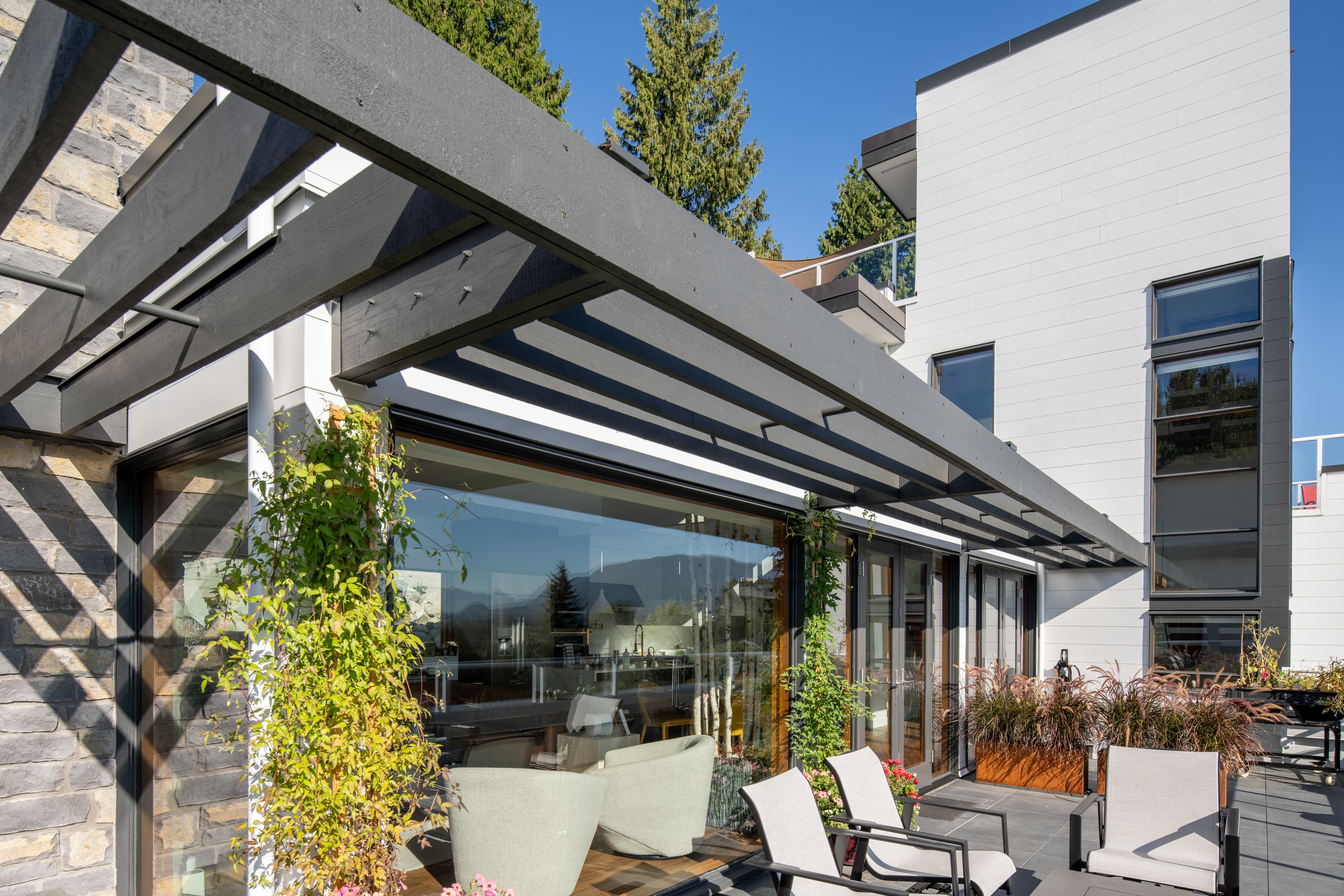 Contemporary - Rooftop deck featuring greenery and a glass sunroom. Building clad in Artisan® lap siding. Rooftop deck featuring greenery and a glass sunroom. Building clad in Artisan lap siding.