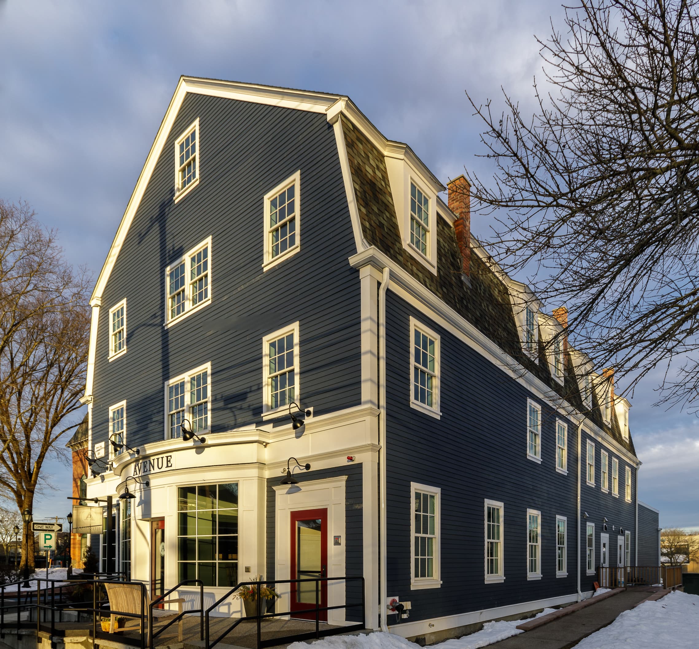 Commercial building in the Dutch Colonial style clad in Deep Ocean Hardie plank lap siding and Arctic White Hardie trim Commercial building in the Dutch Colonial style clad in Deep Ocean Hardie plank lap siding and Arctic White Hardie trim