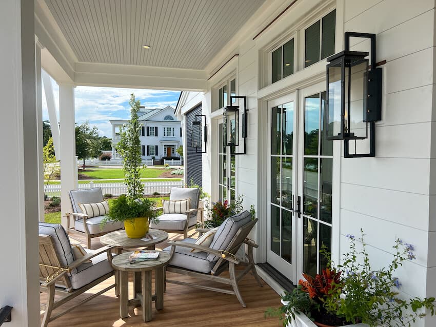 Enhancing Your Home's Exterior: Detail of a porch with large, wrought iron statement sconces. House clad in Hardie® Artisan® Shiplap siding. Detail of a porch with large, wrought iron statement sconces. House clad in Hardie® Artisan® Shiplap siding.
