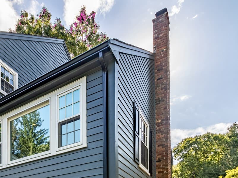 Prepare Your Home for Winter: CLEAN THE CHIMNEY Evening Blue Hardie Lap siding with a brick chimney