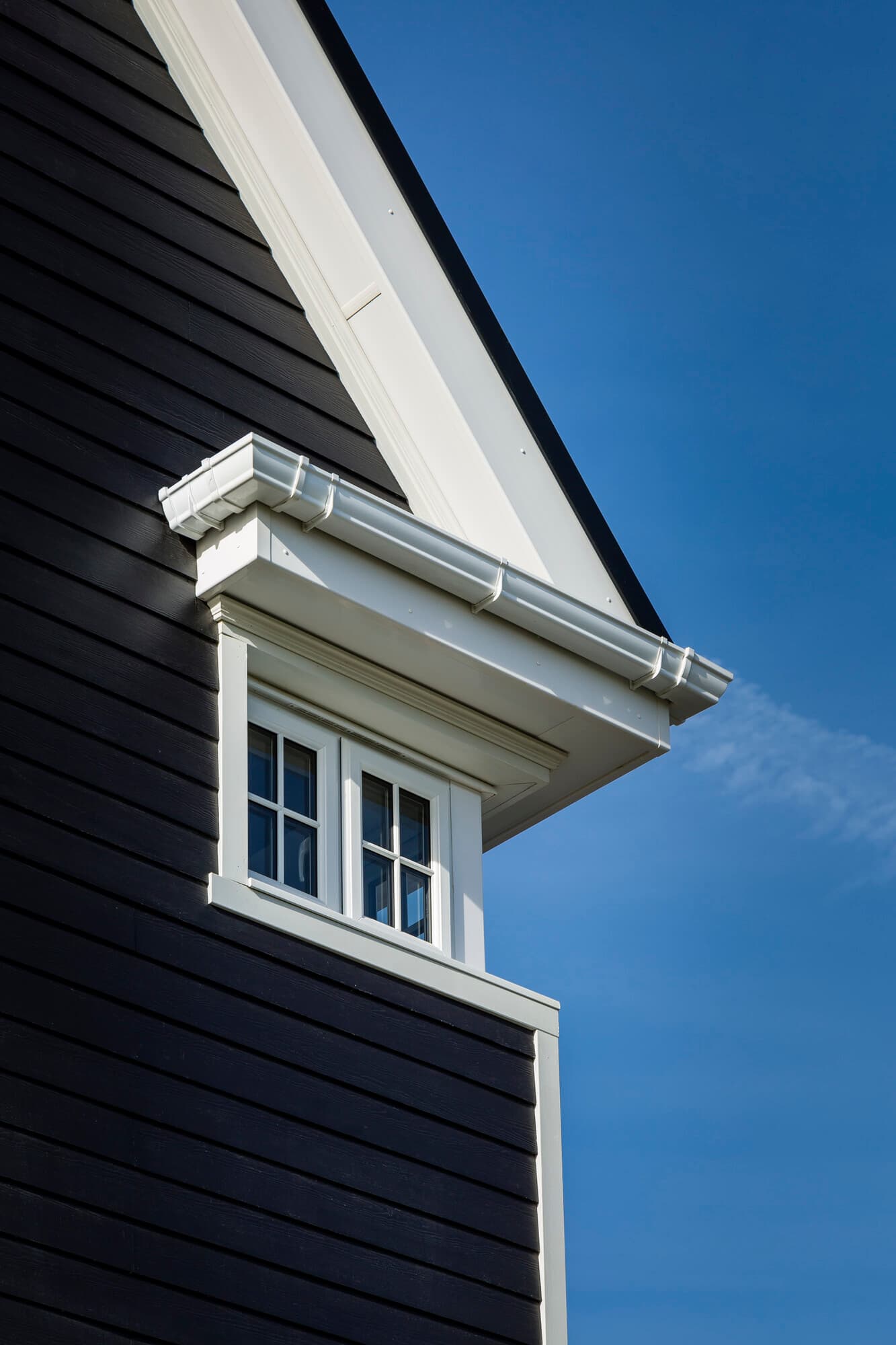 Detail of house with Midnight Black plank lap siding and Arctic White Hardie trim Detail of house with Midnight Black plank lap siding and Arctic White Hardie trim