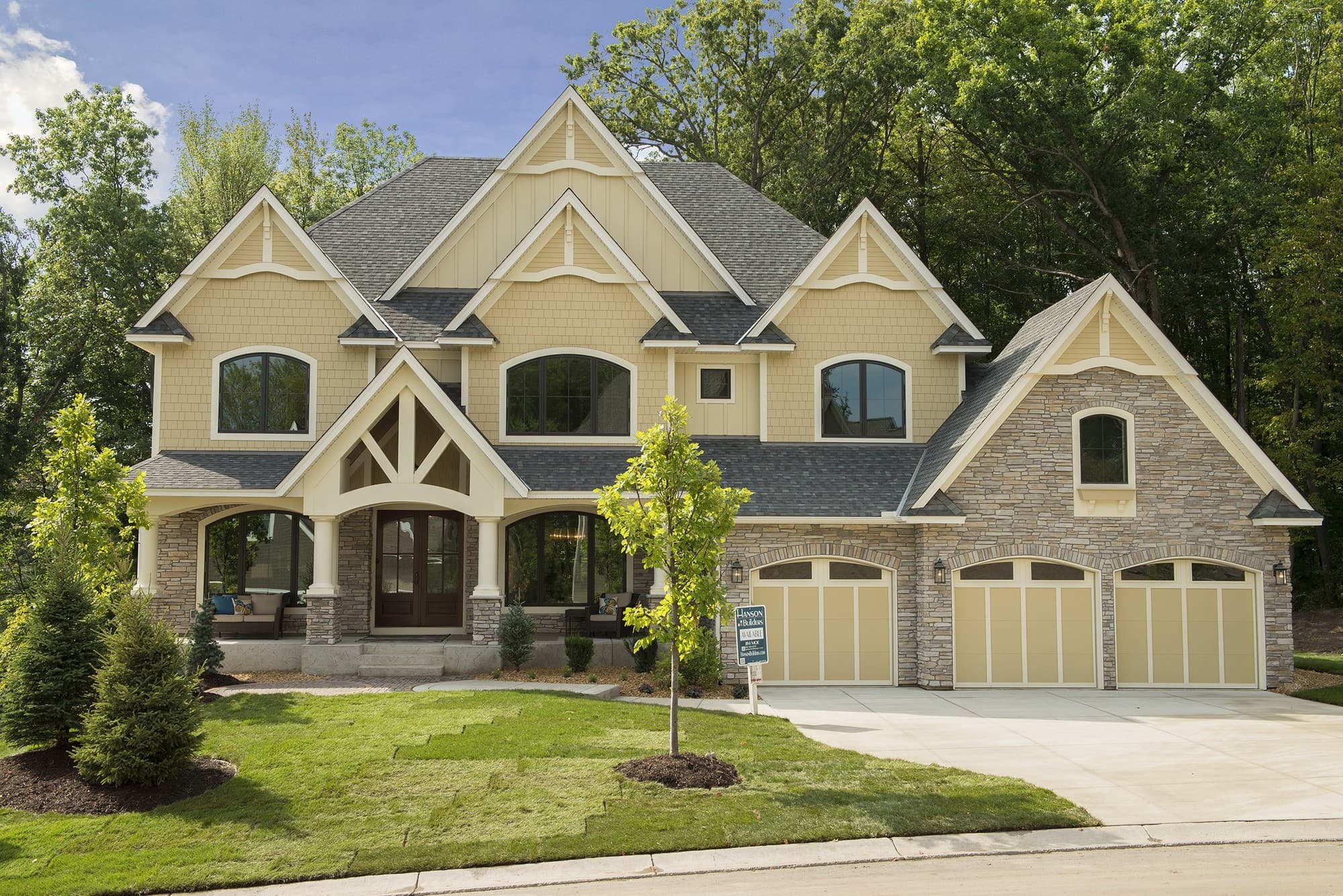Modern interpretation of a Tudor home in Navajo Beige Hardie Panel with Stucco texture. Modern interpretation of a Tudor home in Navajo Beige Hardie Panel with Stucco texture.