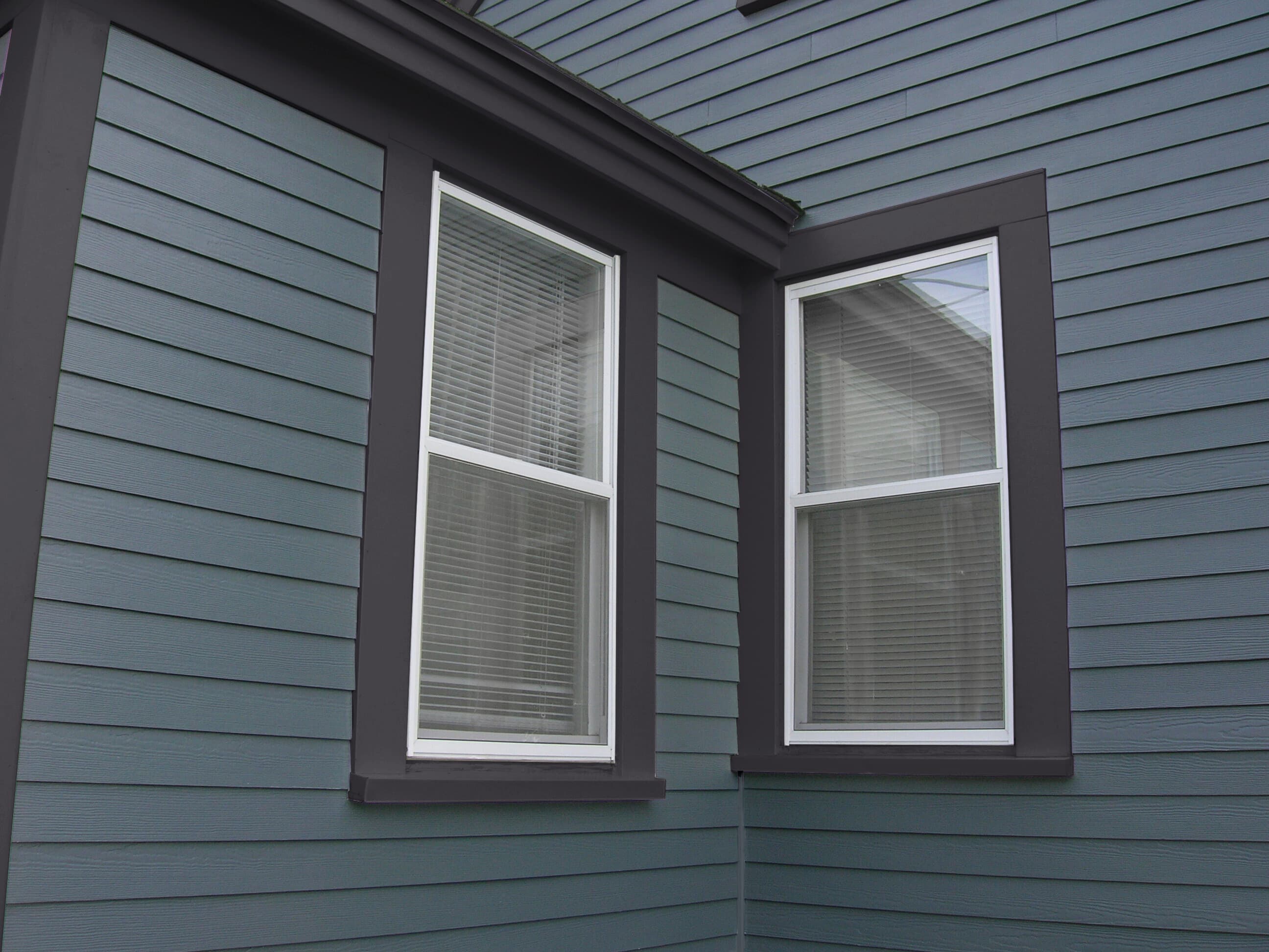 Cape Cod Style - A close up detail of blue Hardie Plank lap with dark blue Hardie Trim  A close up detail of blue Hardie Plank lap with dark blue Hardie Trim