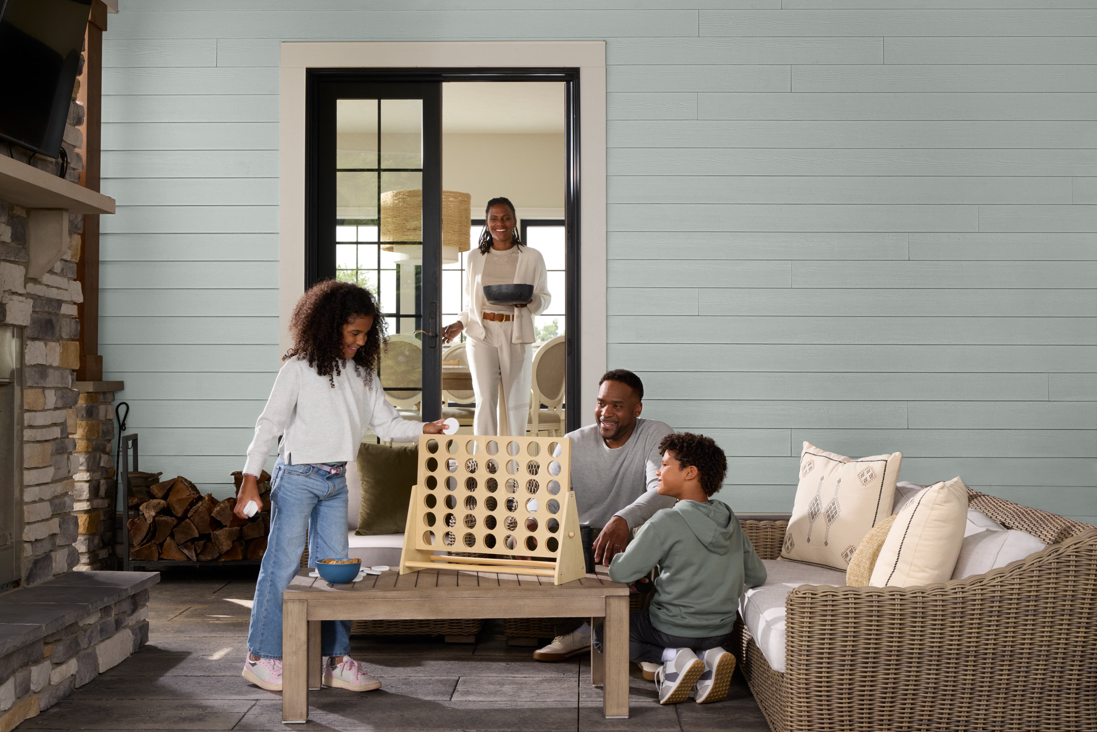 family lifestyle photo hardie plank family playing game outside of house