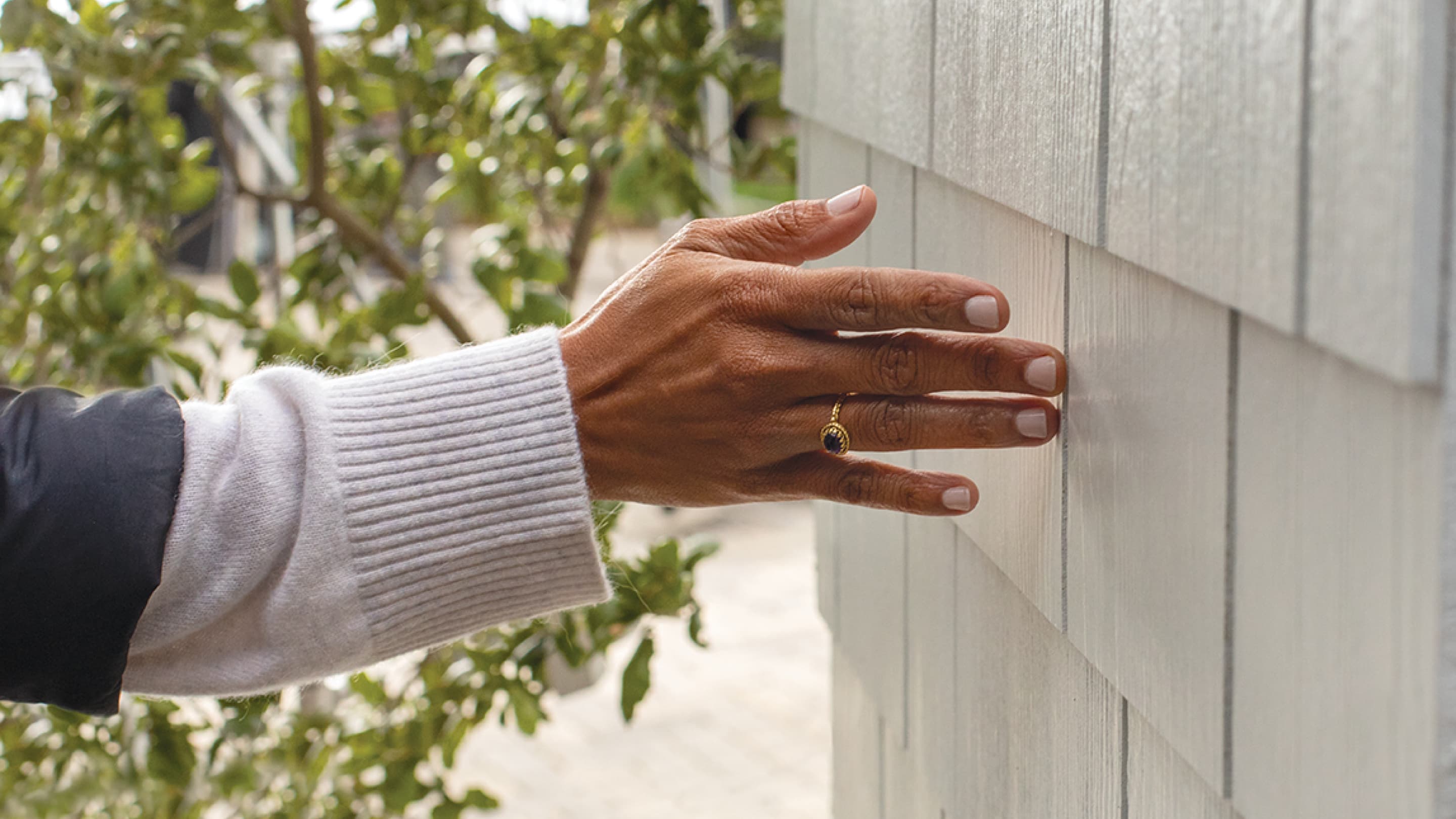 closeup of a hand on hardie shingle arctic white