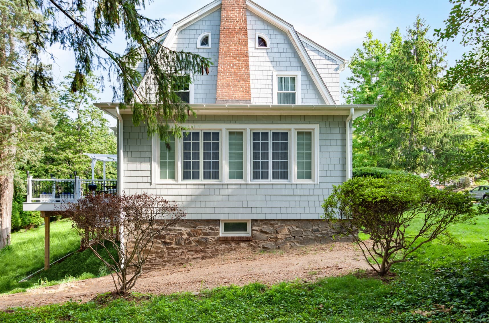 Dutch Colonial house clad in Pearl Gray Hardie Shingle and Arctic White Hardie Trim Dutch Colonial house clad in Pearl Gray Hardie Shingle and Arctic White Hardie Trim