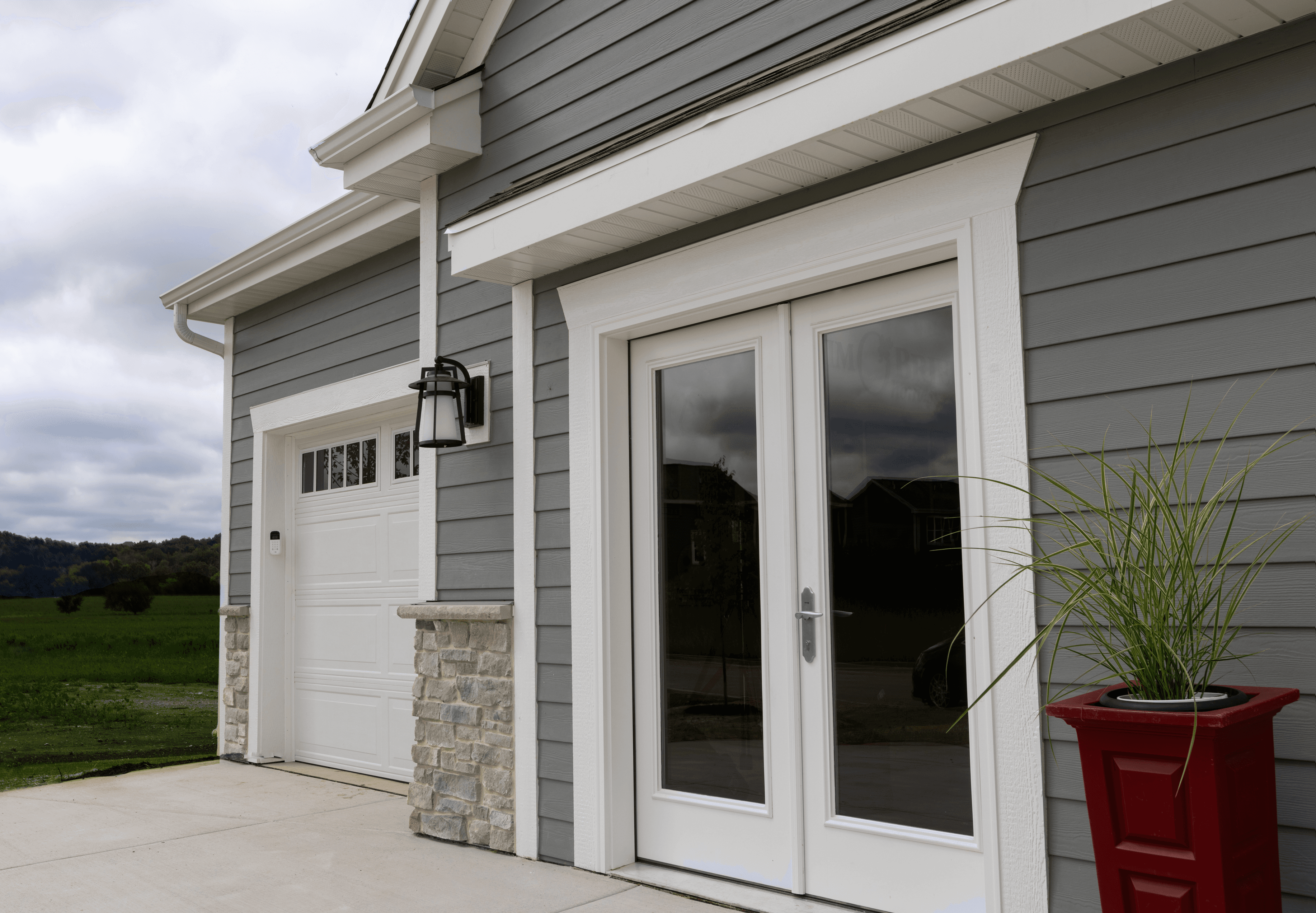 Durability is Sustainability: VISION House Sussex | Close up of Hardie plank siding and garage door Close up of Hardie plank siding and garage door